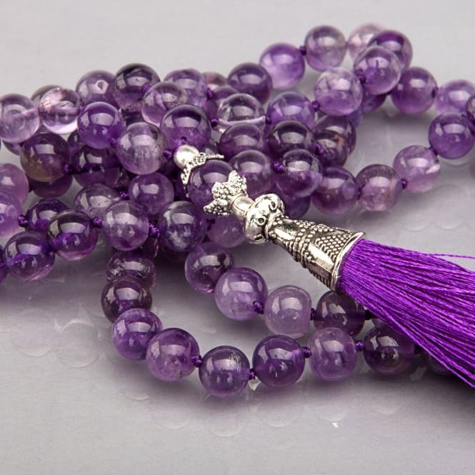 Mala in 108 perline d'ametista, con nappina viola, dettaglio guru bead contenuto in metallo intarsiato