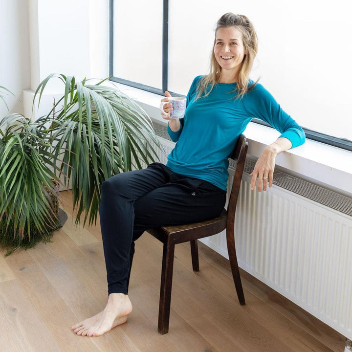 Maglia Easywear con maniche a 3/4, azzurra, con polsini e fascia sui fianchi su modella seduta
